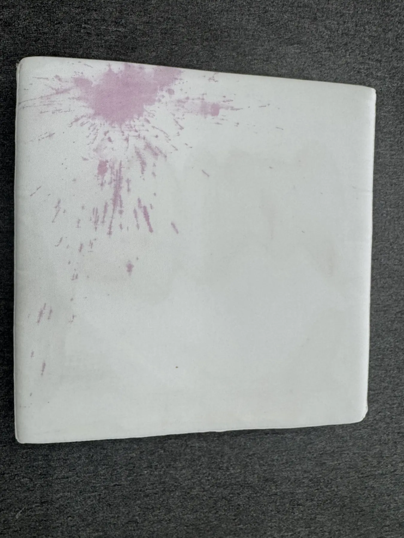 Visible spills and spots on a mattress before professional cleaning