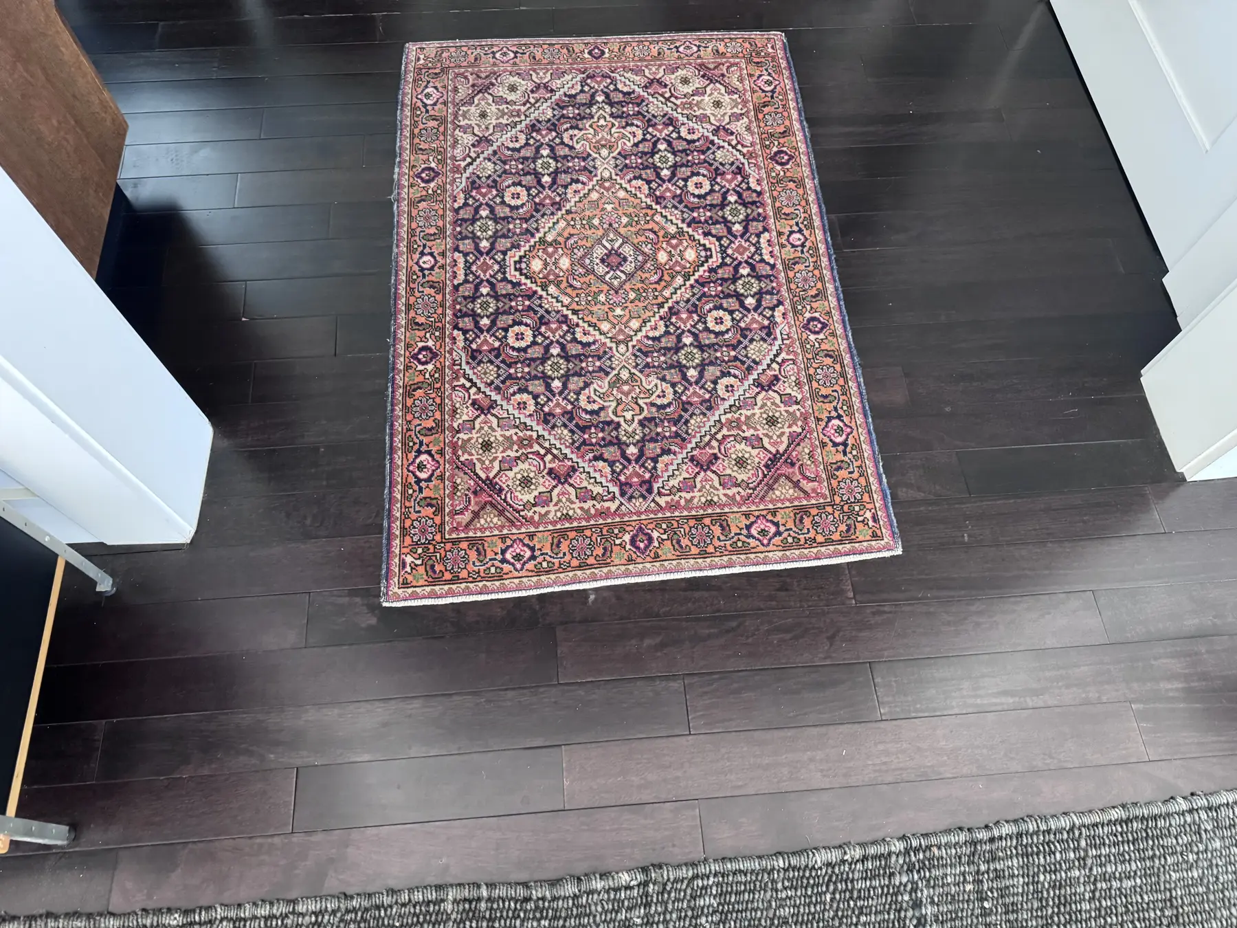 Detailed patterned area rug ready for stain and odor evaluation