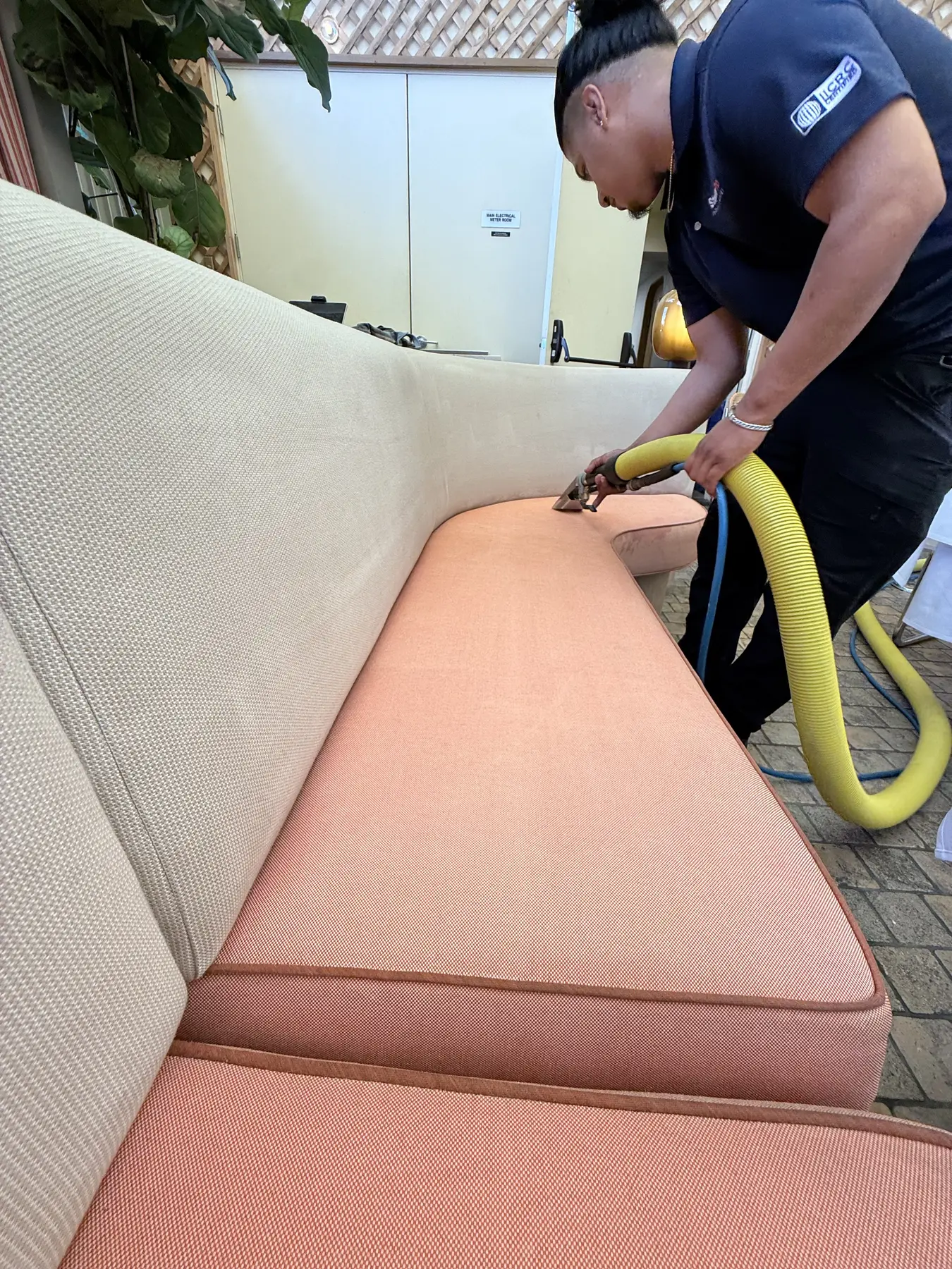 Close-up controlled extraction cleaning a fabric chair