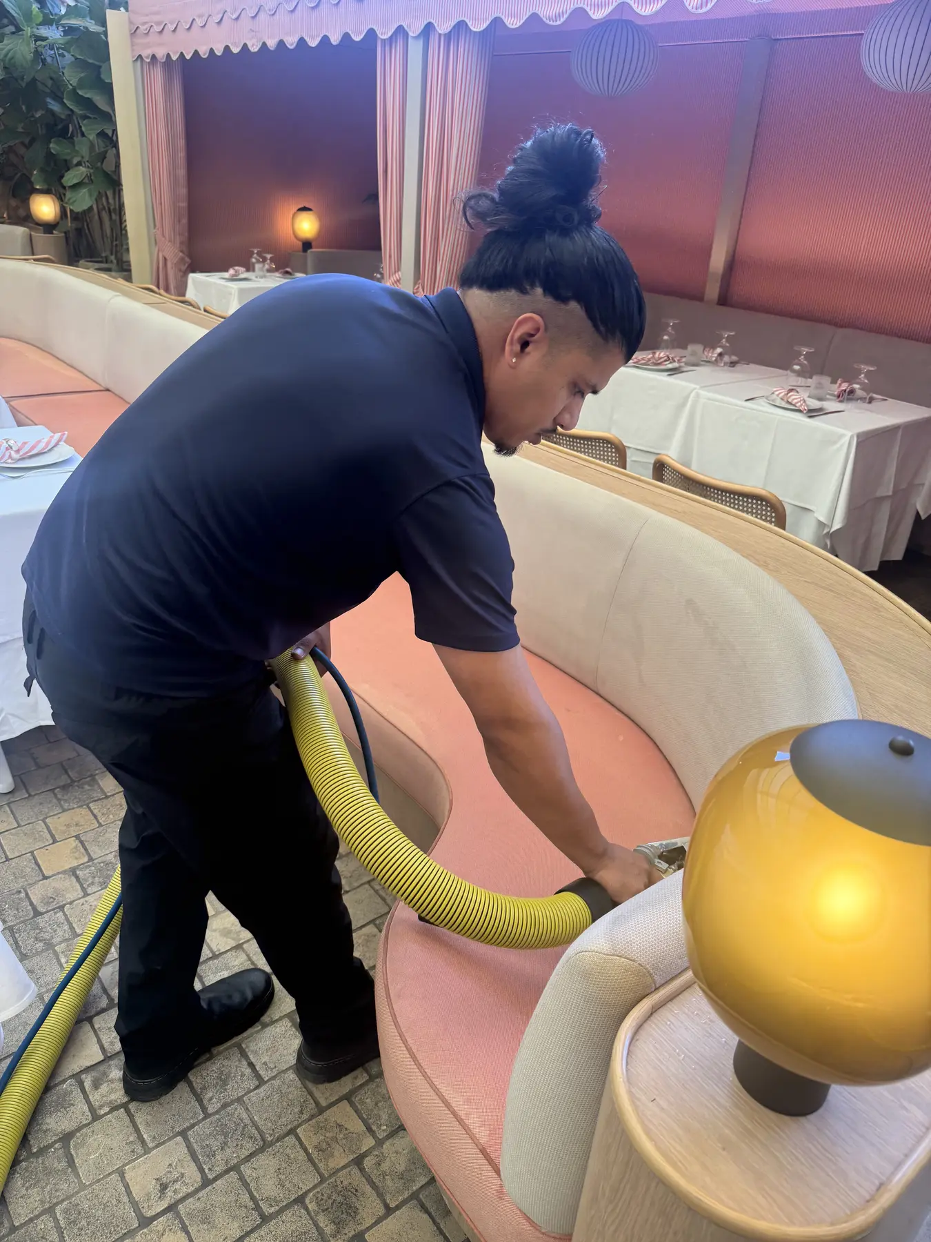 Technician treating the curved back of upholstered seating